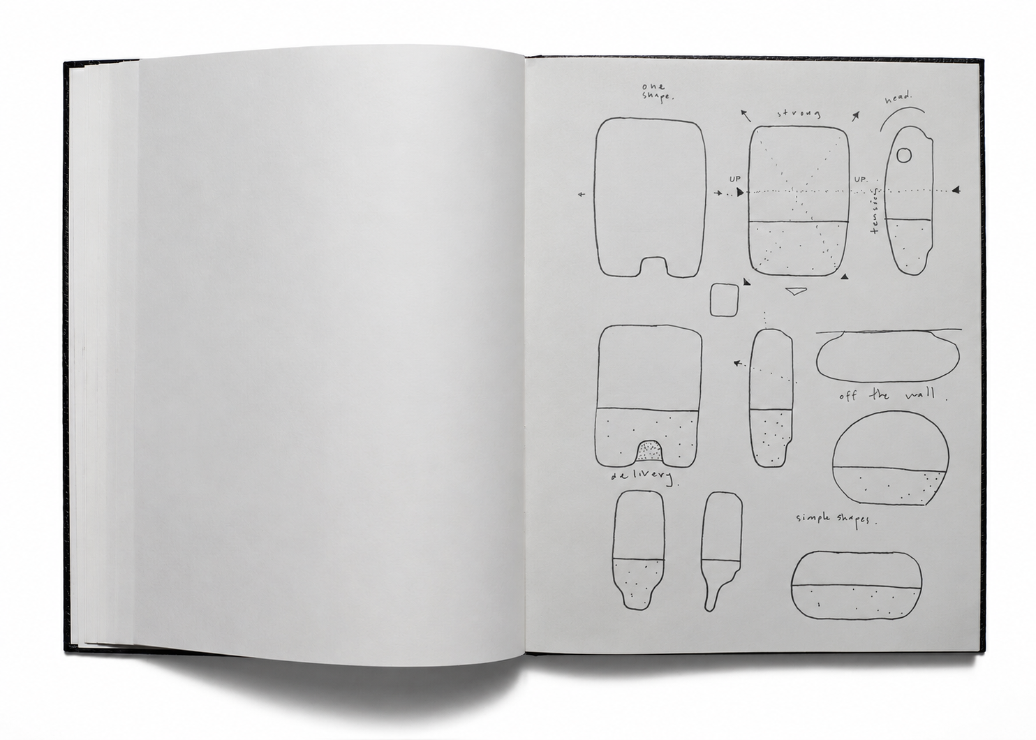 An open sketchbook with hand-drawn studies of paper dispenser shapes